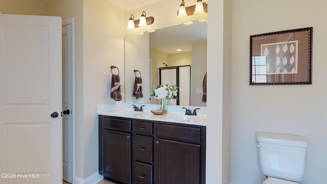 bathroom with vanity, toilet, and an enclosed shower