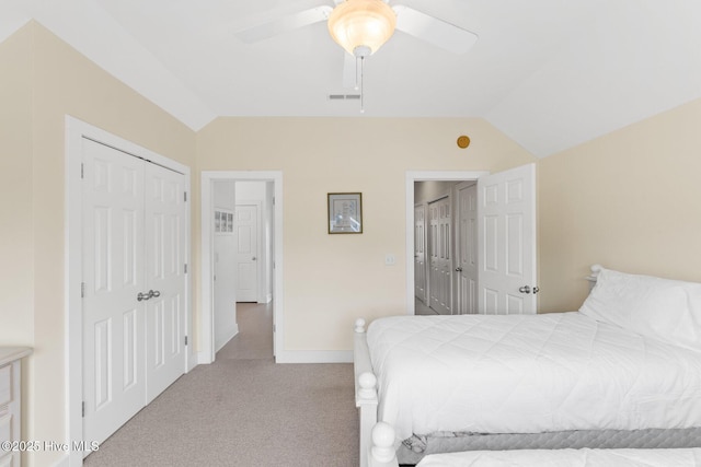 bedroom featuring lofted ceiling, light carpet, a closet, and ceiling fan