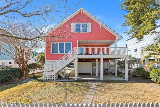 back of house with a patio area, a lawn, and a deck