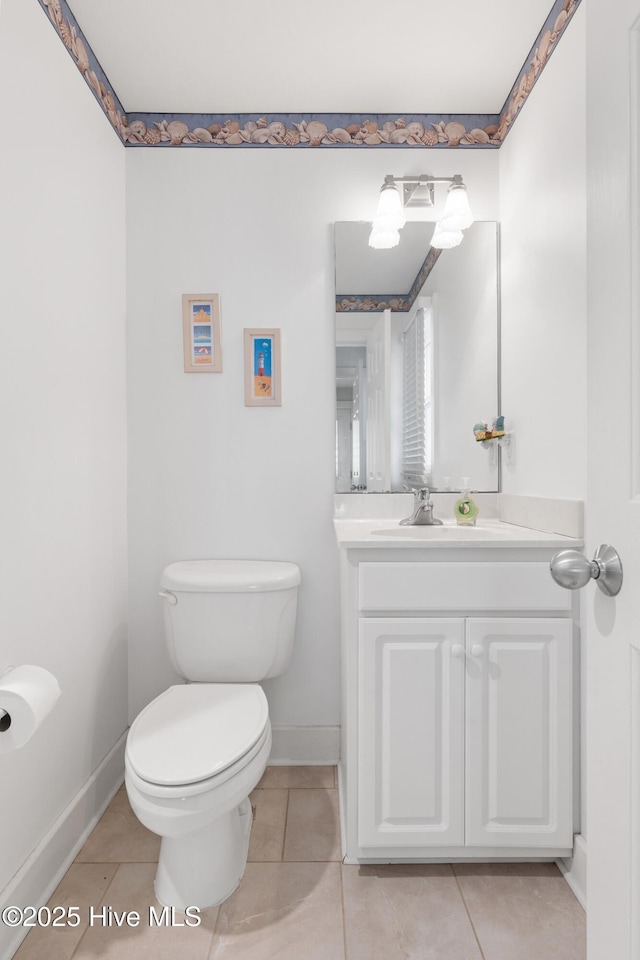 bathroom featuring vanity, tile patterned flooring, and toilet