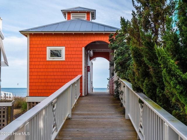 rear view of property with a water view