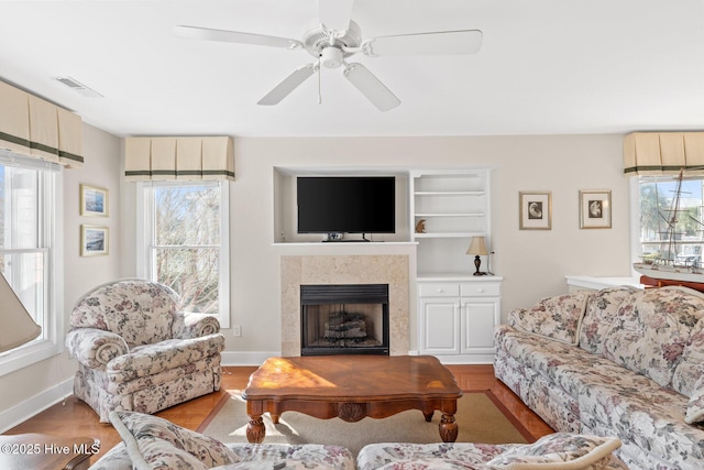 living room with ceiling fan and light hardwood / wood-style floors