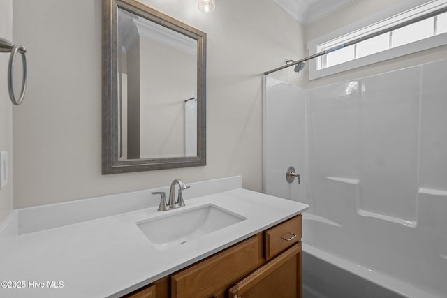 bathroom with shower / bath combination, vanity, and crown molding