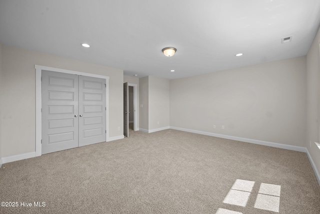 unfurnished bedroom featuring a closet and light carpet