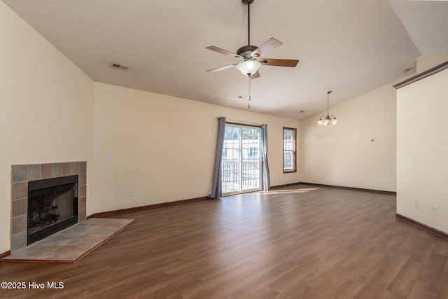 unfurnished living room with ceiling fan, dark hardwood / wood-style flooring, vaulted ceiling, and a tile fireplace