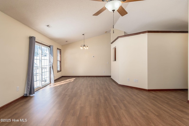 unfurnished living room featuring hardwood / wood-style flooring, lofted ceiling, and ceiling fan with notable chandelier