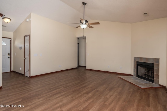 unfurnished living room featuring ceiling fan, lofted ceiling, a fireplace, and dark hardwood / wood-style flooring