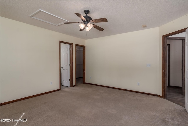 unfurnished room with light colored carpet and a textured ceiling