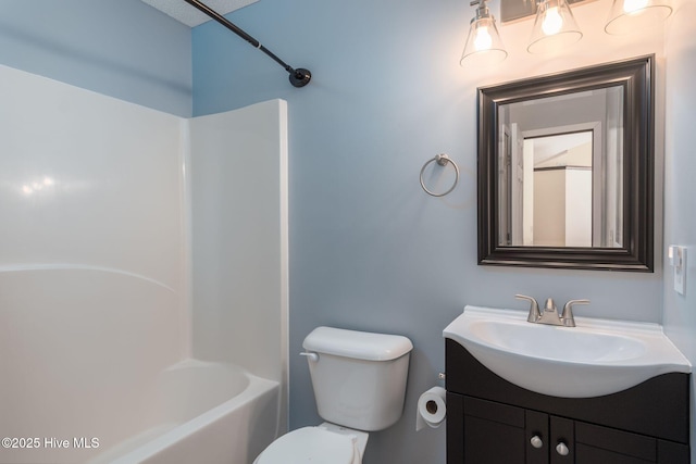 full bathroom with vanity, shower / bathtub combination, and toilet