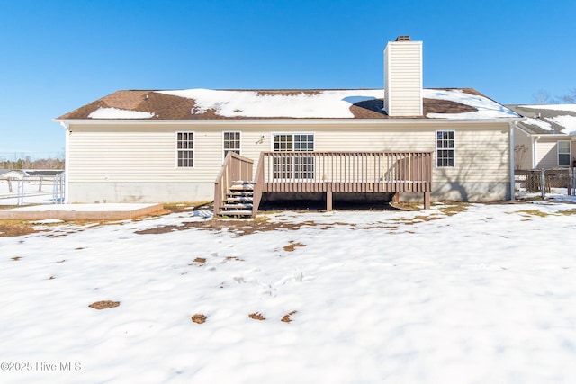 snow covered property featuring a wooden deck