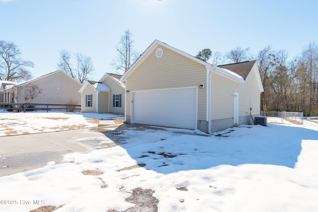 view of front of property with cooling unit and a garage