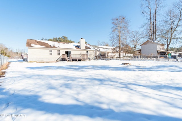 view of snow covered rear of property