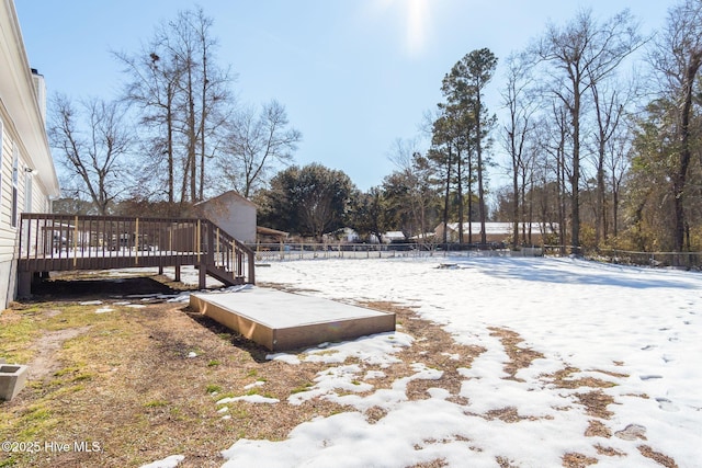 yard layered in snow featuring a wooden deck