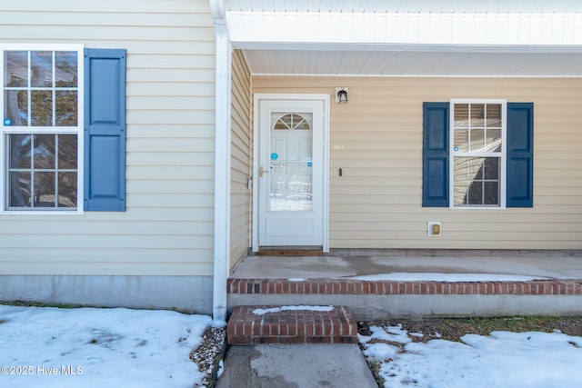 view of snow covered property entrance