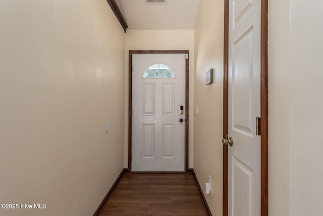 entryway featuring dark wood-type flooring and a textured ceiling