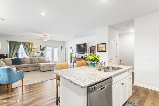 kitchen with sink, a center island with sink, dishwasher, hardwood / wood-style flooring, and white cabinets