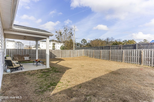 view of yard with a patio area and ceiling fan