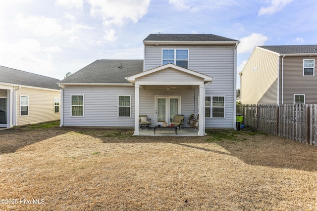 back of property with a patio, a yard, and ceiling fan