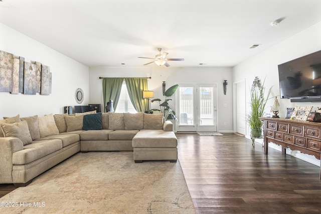 living room with dark wood-type flooring and ceiling fan