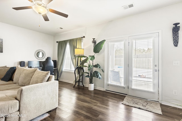 living room with dark wood-type flooring and ceiling fan