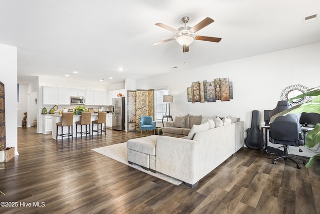 living room featuring dark hardwood / wood-style flooring and ceiling fan