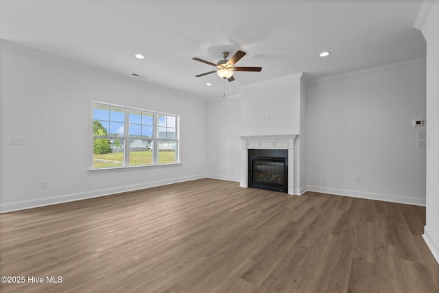 unfurnished living room with ceiling fan, crown molding, and wood-type flooring