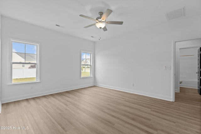 spare room with light wood-type flooring and ceiling fan