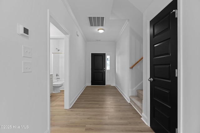 entrance foyer featuring light wood-type flooring and ornamental molding