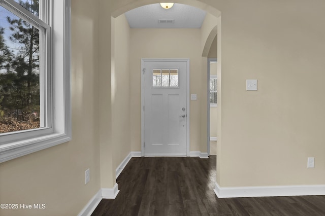 interior space with dark wood-type flooring and a textured ceiling