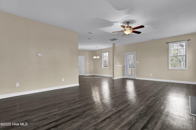 unfurnished room featuring dark hardwood / wood-style floors and ceiling fan with notable chandelier