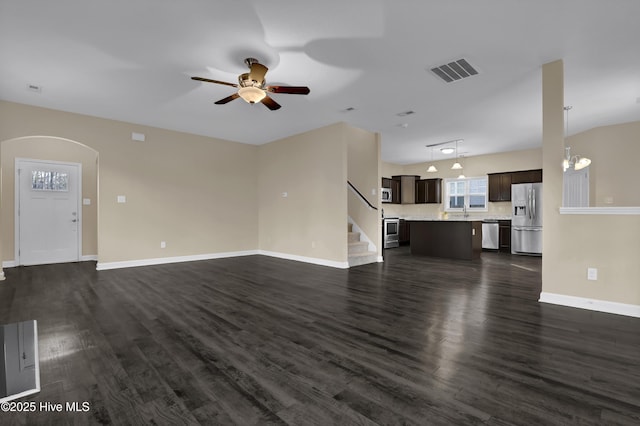 unfurnished living room with ceiling fan, rail lighting, sink, and dark hardwood / wood-style flooring