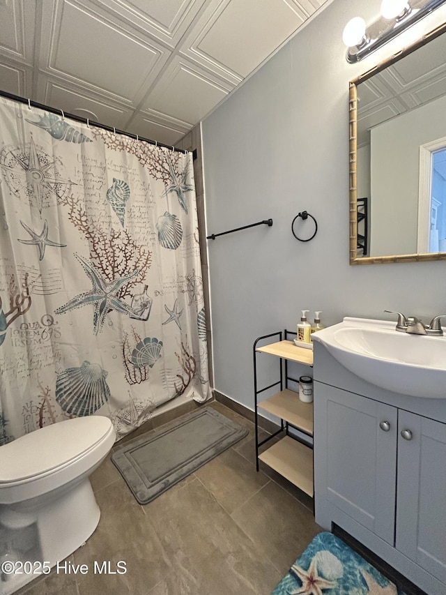 bathroom featuring vanity, tile patterned floors, and toilet