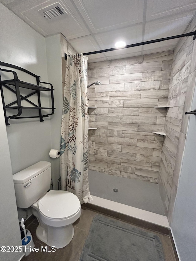 bathroom with curtained shower and toilet