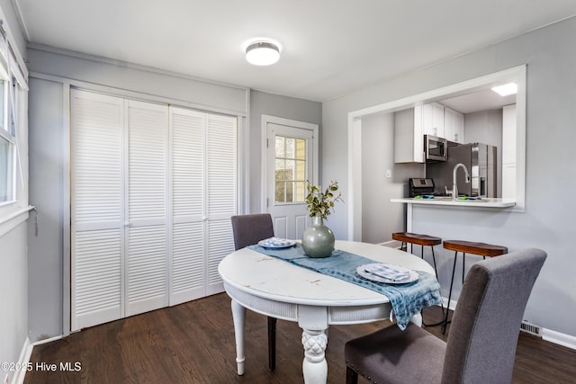 dining area featuring dark hardwood / wood-style floors