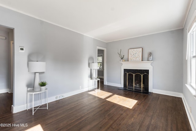 unfurnished living room featuring dark hardwood / wood-style flooring, ornamental molding, and a fireplace