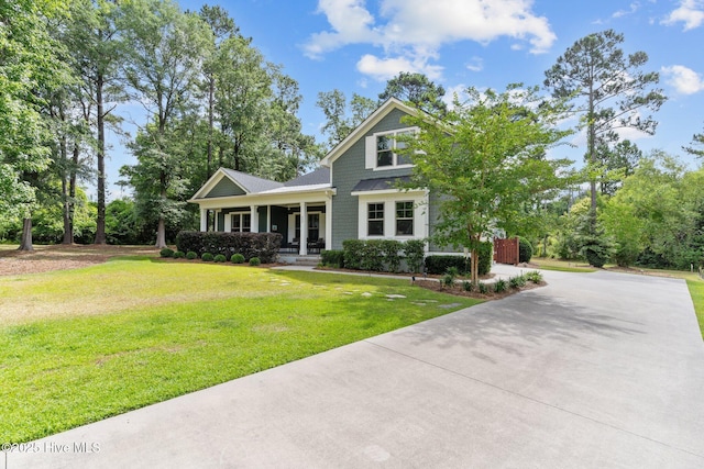 craftsman-style house featuring a front yard and covered porch