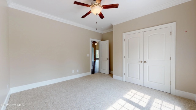 unfurnished bedroom featuring light carpet, a closet, ceiling fan, and ornamental molding