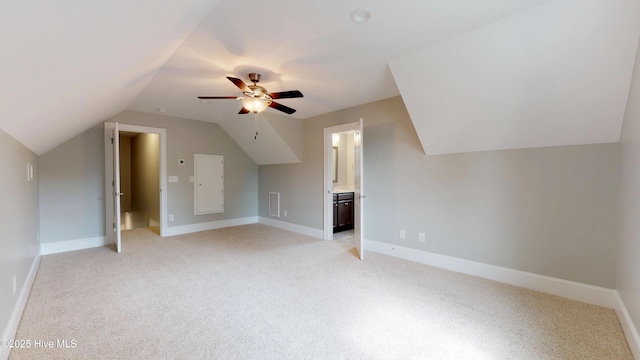 additional living space featuring light carpet, vaulted ceiling, and ceiling fan