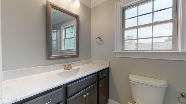 bathroom with vanity, toilet, and ornamental molding