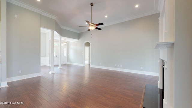 unfurnished living room featuring ornamental molding, ceiling fan, ornate columns, and dark hardwood / wood-style floors