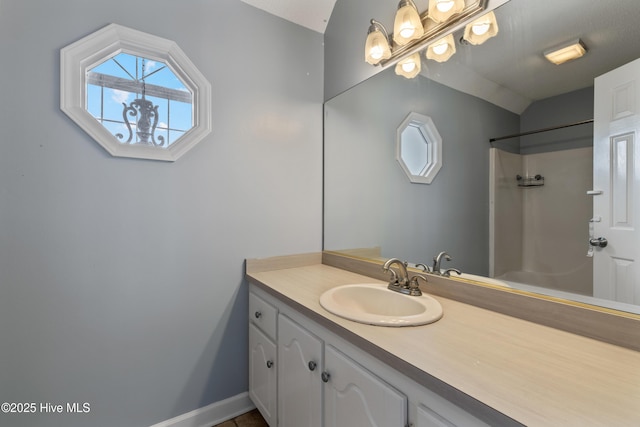 bathroom featuring vanity and a shower