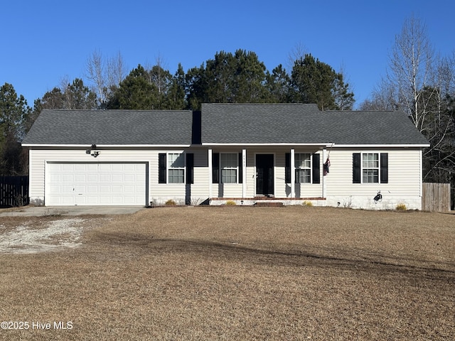 ranch-style home featuring a garage, covered porch, and a front lawn