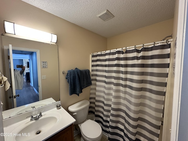 bathroom featuring vanity, a textured ceiling, toilet, and a shower with shower curtain