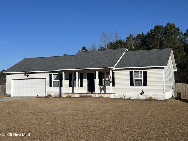 ranch-style house featuring a garage, a front yard, and covered porch