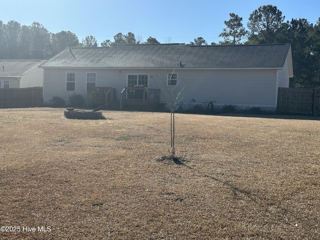 rear view of property with a yard and a deck