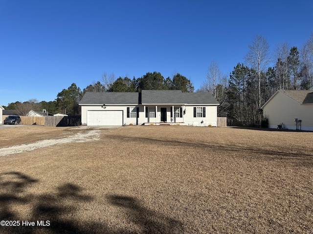 ranch-style house with a garage and a front lawn