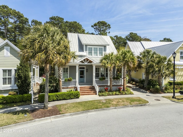 view of front of property featuring covered porch and metal roof