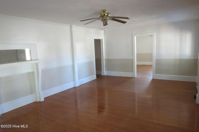 unfurnished room featuring ceiling fan, crown molding, baseboards, and wood finished floors