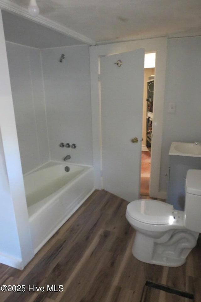 bathroom featuring a sink, toilet, and wood finished floors