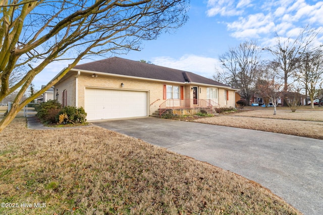 ranch-style home with a garage and a front lawn